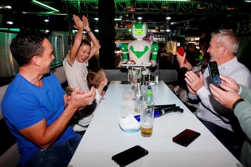 A robot delivers a birthday cake at Robotazia restaurant as the coronavirus disease (COVID-19) outbreak continues in Milton Keynes, Britain, October 2, 2020. REUTERS/Andrew Boyers/File Photo